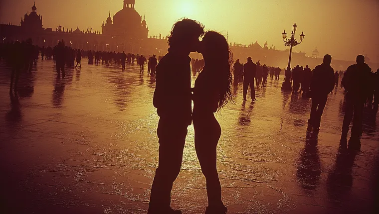 Man and woman kissing in a crowded square at sunset, demonstrating public displays of affection in a relationship